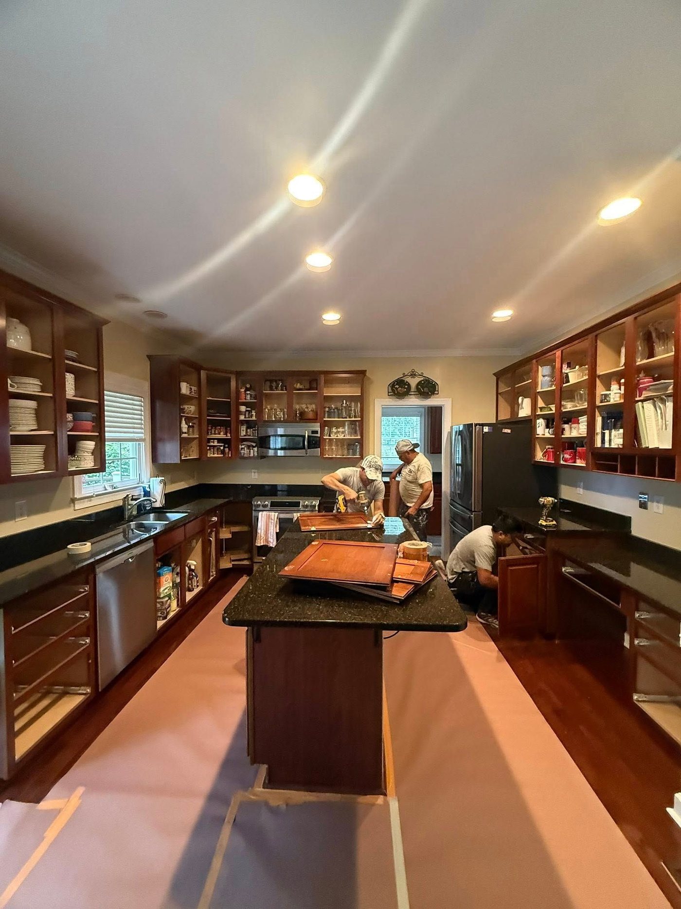 The crew mid-renovation, cabinet doors off for refinishing