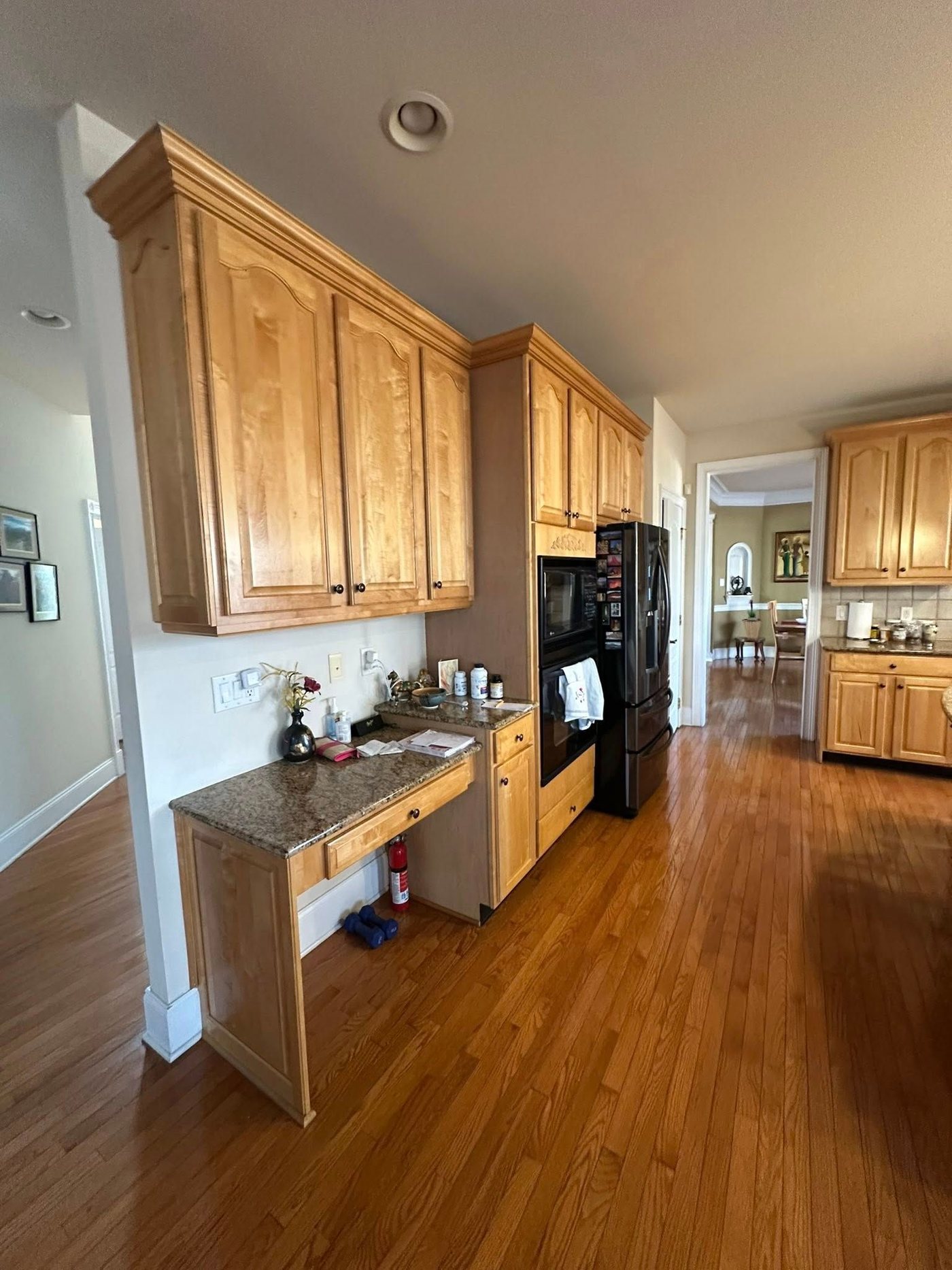 Honey-oak cabinets and black appliances before