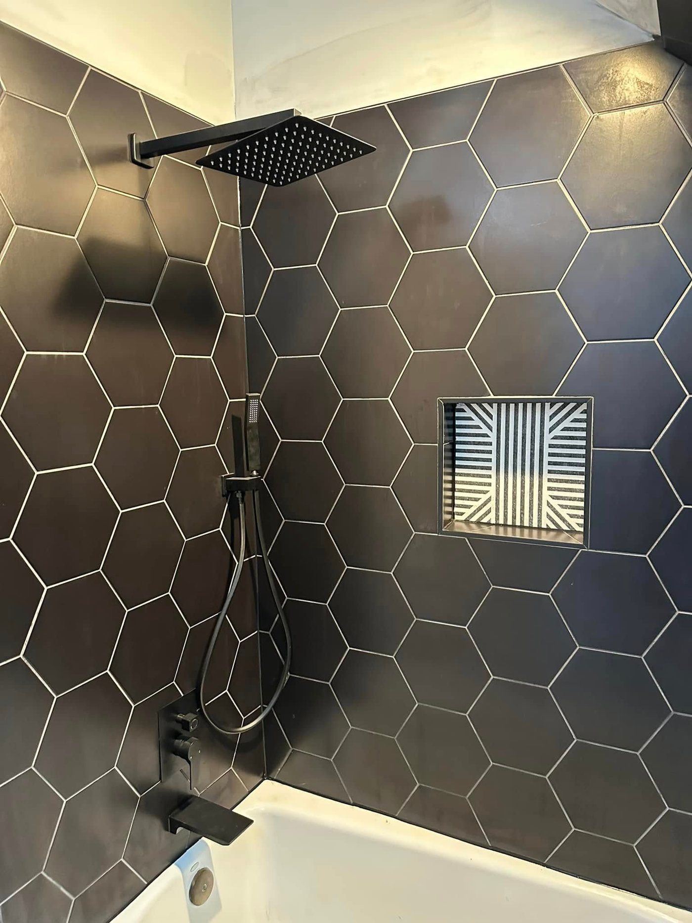 Shower in black hexagon tile