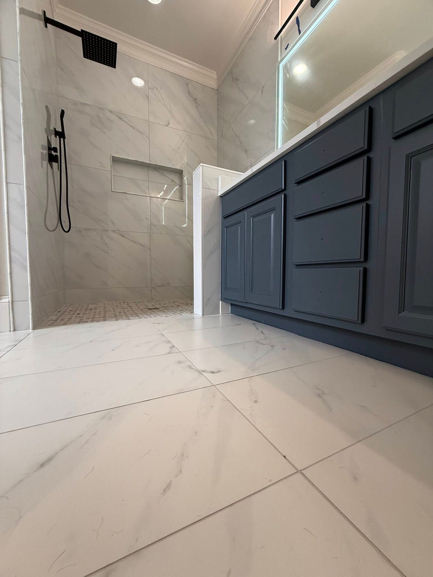 Marble bathroom with navy vanity