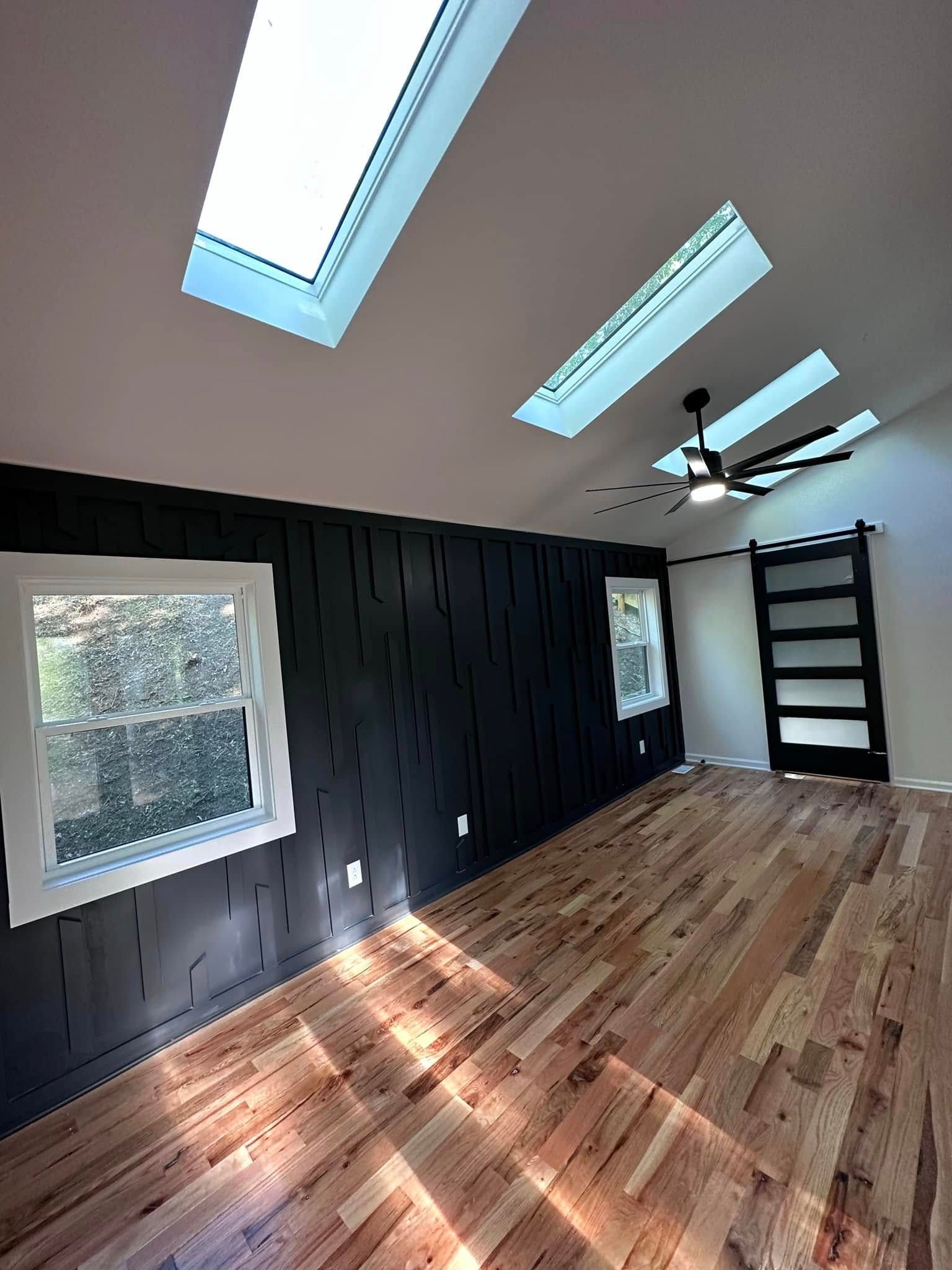 Bedroom with painted black accent wall