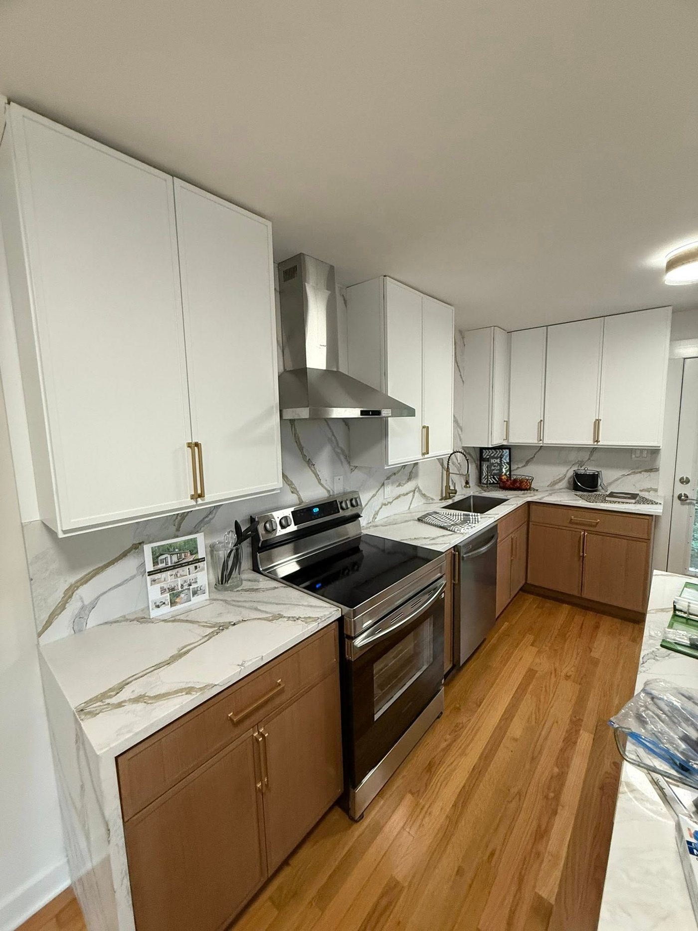Kitchen with marble backsplash and stainless hood