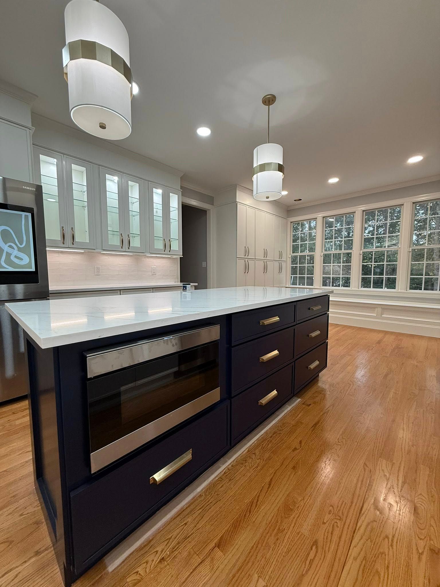 Navy island kitchen remodel with gold hardware